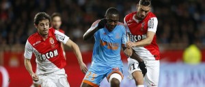 Marseille's French midfielder Giannelli Imbula (C) vies with Monaco's Portuguese midfielder Silva Bernardo (L) and Monaco's Belgian midfielder Yannick Ferreira Carrasco (R) during the French L1 football match Monaco (ASM) vs Marseille (OM) on December 14, 2014 at the "Louis II" stadium in Monaco.  AFP PHOTO / VALERY HACHE        (Photo credit should read VALERY HACHE/AFP/Getty Images)